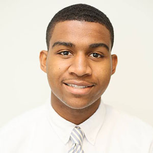 Headshot of 2016 scholarship winner Michael Burton  wearing white dress shirt and grey striped tie