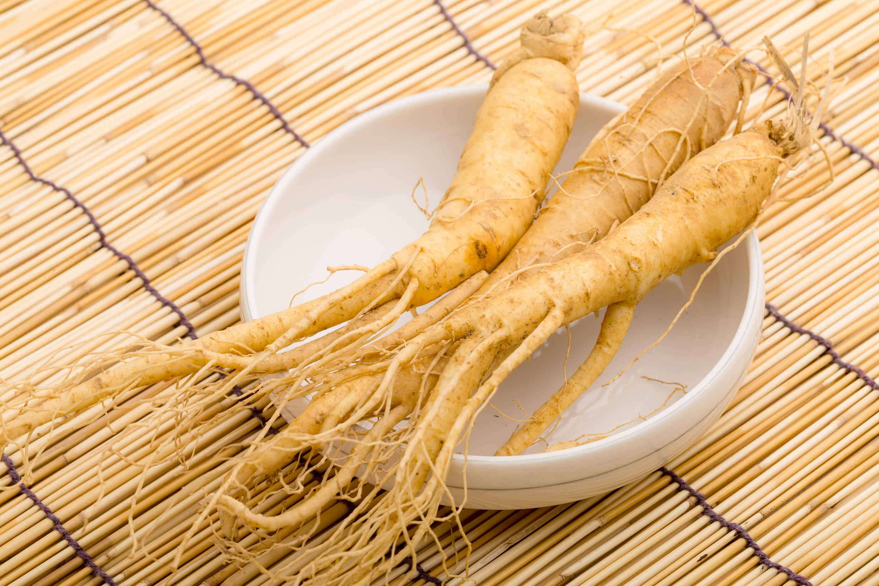 Fresh Ginseng on a white bowl on top of reed material