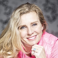 Headshot of Ms. Andrea Metcalf. She is wearing a pink jacke and has blonde hair